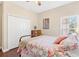 Comfortable bedroom featuring dark wood floors, closet, and windows that allow lots of natural light at 973 Belle Oak Dr, Leesburg, FL 34748