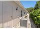 Home exterior featuring an air conditioning unit, access door, and side yard at 973 Belle Oak Dr, Leesburg, FL 34748