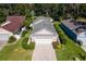 Charming home featuring a well-manicured lawn, beautiful landscaping, and an oversized two car garage at 973 Belle Oak Dr, Leesburg, FL 34748