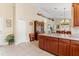 Spacious kitchen boasts ample counter space, stylish cabinets, and tile flooring, with an adjacent dining area visible at 973 Belle Oak Dr, Leesburg, FL 34748