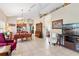 Open-concept living room with kitchen and dining area, vaulted ceilings, tile flooring, and a neutral color palette at 973 Belle Oak Dr, Leesburg, FL 34748