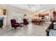 Bright and airy living room with a fireplace, large windows, tile floors, and comfortable seating arrangements at 973 Belle Oak Dr, Leesburg, FL 34748