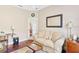 Comfortable sitting area with hardwood floors, a sofa, and a desk at 973 Belle Oak Dr, Leesburg, FL 34748