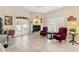 Inviting living room with a fireplace, French doors, tile flooring, and plush seating, perfect for relaxation at 973 Belle Oak Dr, Leesburg, FL 34748