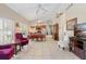 Spacious living room with tile floors, vaulted ceilings, and an open layout leading to the dining area and kitchen at 973 Belle Oak Dr, Leesburg, FL 34748