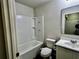 Bathroom with tub, white toilet, sink and modern vanity, ready for relaxation at 209 Hyacinth Ct, Kissimmee, FL 34759