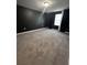 The spacious bedroom offers carpet floors, a window, and dark walls at 209 Hyacinth Ct, Kissimmee, FL 34759