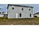 Back of two-story house, showing the siding, yard, back door and windows at 209 Hyacinth Ct, Kissimmee, FL 34759