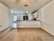 Open-concept floor plan connects living area with kitchen, featuring neutral colors and carpeting at 209 Hyacinth Ct, Kissimmee, FL 34759