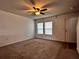 Spacious living room with carpet, ceiling fan, and a window with natural light at 209 Hyacinth Ct, Kissimmee, FL 34759