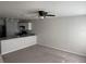 Open-concept living area featuring neutral walls, gray carpeting, and a ceiling fan at 209 Hyacinth Ct, Kissimmee, FL 34759