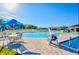 Great community pool with splash pad, seating, and blue umbrellas at 209 Hyacinth Ct, Kissimmee, FL 34759