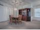 Cozy dining room featuring a wooden table set, corner cabinet, and ample natural light at 32619 Oak Park Dr, Leesburg, FL 34748