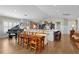Spacious open-concept kitchen with island seating, stainless steel appliances, and adjacent dining areas at 3469 Melbourne Ln, The Villages, FL 32163