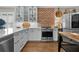 Stainless steel stove with brick design and kitchen cabinets, countertops, and updated appliances at 3469 Melbourne Ln, The Villages, FL 32163