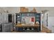 Kitchen hutch with glassware next to stainless steel refrigerator and adjacent wainscotting at 3469 Melbourne Ln, The Villages, FL 32163