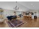 Open living area with hardwood floors, grand piano, chandelier, and abundant natural light at 3469 Melbourne Ln, The Villages, FL 32163