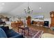Large living room featuring hardwood floors, ample seating, and an elegant chandelier at 3469 Melbourne Ln, The Villages, FL 32163
