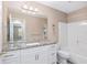 Bathroom with granite countertop, white cabinets and tile shower at 647 San Pedro Dr, The Villages, FL 32159