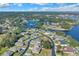 Scenic aerial shot of a residential neighborhood by a tranquil lake with homes nestled among trees, under clear blue skies at 8 Diamond Club Rd, Ocala, FL 34472