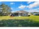 Beautiful backyard with lush lawn, screened patio, and mature trees, perfect for outdoor entertaining at 8 Diamond Club Rd, Ocala, FL 34472