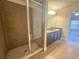 Bathroom featuring a tiled walk-in shower, dual sink vanity, and tile flooring at 8 Diamond Club Rd, Ocala, FL 34472
