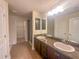 Bathroom with dual vanity, tile flooring, walk-in shower, and a walk-in closet at 8 Diamond Club Rd, Ocala, FL 34472