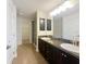 Bathroom showcasing dual vanities with a large mirror and a walk in closet in view at 8 Diamond Club Rd, Ocala, FL 34472