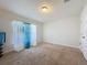 Cozy bedroom featuring soft carpet and ample natural light at 8 Diamond Club Rd, Ocala, FL 34472