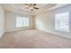 Generously sized main bedroom offering neutral carpeting and tray ceiling with ceiling fan at 8 Diamond Club Rd, Ocala, FL 34472