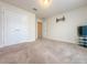 Bedroom featuring neutral carpet, adjacent doorways, and tv hookups at 8 Diamond Club Rd, Ocala, FL 34472