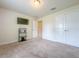 Bedroom featuring carpeted floor, a tv and media center, closet with paneled doors and door into hallway at 8 Diamond Club Rd, Ocala, FL 34472