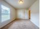 Bedroom featuring carpeted floor, bright window and closet with paneled doors at 8 Diamond Club Rd, Ocala, FL 34472