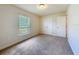 Bright bedroom with a window, carpet, and a closet at 8 Diamond Club Rd, Ocala, FL 34472