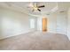 Comfortable bedroom offering neutral carpeting, a ceiling fan and window views at 8 Diamond Club Rd, Ocala, FL 34472