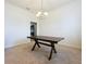 Minimalist dining area with a large table, carpet flooring, and natural light at 8 Diamond Club Rd, Ocala, FL 34472