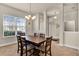 Comfortable dining room with a large window providing natural light and seating for six at 8 Diamond Club Rd, Ocala, FL 34472