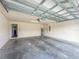 Spacious garage featuring bare concrete flooring and water heater at 8 Diamond Club Rd, Ocala, FL 34472