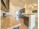 Modern kitchen features granite countertops, stainless steel appliances, and dark cabinetry at 8 Diamond Club Rd, Ocala, FL 34472