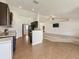 Open kitchen design with dark cabinets, granite counters, and a view into the living space at 8 Diamond Club Rd, Ocala, FL 34472