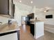 Spacious kitchen with granite countertops, black cabinets, and stainless steel appliances at 8 Diamond Club Rd, Ocala, FL 34472
