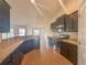 Contemporary kitchen with stainless steel appliances and granite countertops, open to dining area at 8 Diamond Club Rd, Ocala, FL 34472