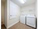 Laundry room featuring tile floors, bright lighting, and new washer and dryer at 8 Diamond Club Rd, Ocala, FL 34472