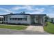 Charming single-story home with carport and manicured lawn, perfect for comfortable living at 117 Hibiscus Way, Leesburg, FL 34748