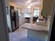 Efficient kitchen featuring stainless steel appliances and a breakfast bar overlooking the dining area at 117 Hibiscus Way, Leesburg, FL 34748