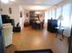 Open-concept living area with wood floors and dining space featuring ample natural light at 117 Hibiscus Way, Leesburg, FL 34748