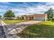 Charming single-story home featuring a well-manicured lawn and inviting curb appeal at 1233 Carvello Dr, The Villages, FL 32162