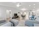 Open-concept living space with dining area, wood floors and natural light at 1233 Carvello Dr, The Villages, FL 32162