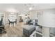 Open-concept living space featuring stylish furniture, wood floors and modern decor at 1233 Carvello Dr, The Villages, FL 32162