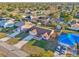 Aerial view of a home with a spacious yard, mature trees, and a long driveway in a residential neighborhood at 1907 E Chapel Dr, Deltona, FL 32738